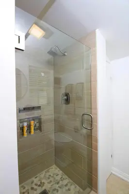 a shower with a glass door in a bathroom at In The Village With Private Entrance in Claremont