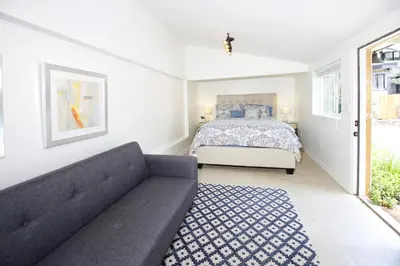 a living room with a bed and a couch at In The Village With Private Entrance in Claremont