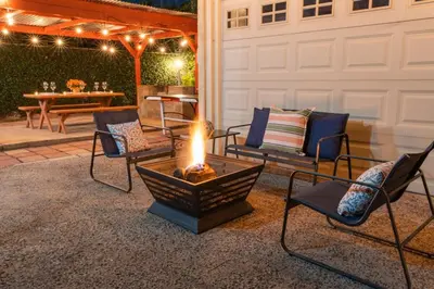 a fire pit on a patio with chairs and a table at LA Karaoke Fire Pit Ping-Pong Cowboy Pool in Glendale