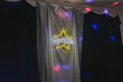 a curtain with a rockstar sign on it at LA Karaoke Fire Pit Ping-Pong Cowboy Pool in Glendale