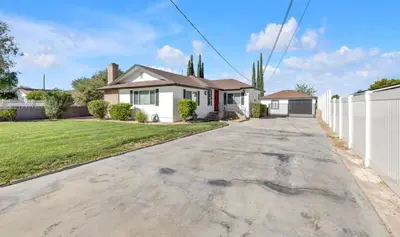 a house with a white fence and a driveway at Vacation-Poppy Fields, Antelope Valley & Aerospace in Lancaster