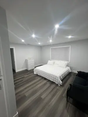 a white bedroom with a bed and a couch at Vacation-Poppy Fields, Antelope Valley & Aerospace in Lancaster
