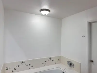 a bathroom with a white wall with black butterflies on the wall at Coastal haven retreat in Los Angeles