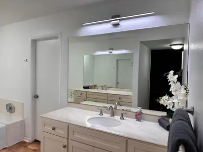 a bathroom with a sink and a large mirror at Coastal haven retreat in Los Angeles