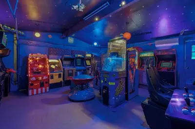 a room with arcade games and a video game at Mickeys House by OC Adventure Homes in Anaheim