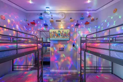 a room with two bunk beds with colorful lights at Mickeys House by OC Adventure Homes in Anaheim