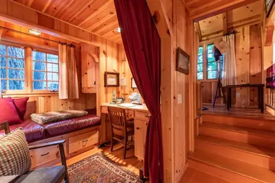 a kitchen and living room in a log cabin at Contemporary Classic on a Private Mountain Lake in Lake Arrowhead