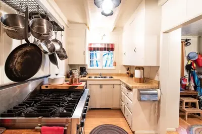 a kitchen with a stove and some pots and pans at Contemporary Classic on a Private Mountain Lake in Lake Arrowhead