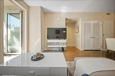 a living room with a couch and a table at Chic 1BR Retreat with Pool, Gym & Jacuzzi in Mid Wilshire & Miracle Mile in Los Angeles