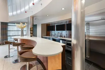 a kitchen with a large island with a counter top at Chic 1BR Retreat with Pool, Gym & Jacuzzi in Mid Wilshire & Miracle Mile in Los Angeles
