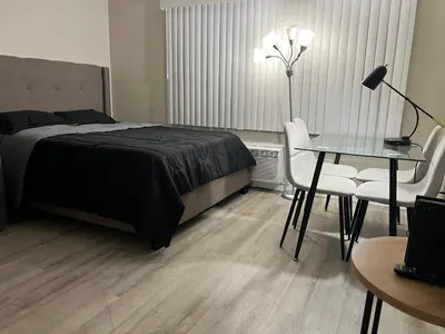a bedroom with a bed and a table and chairs at NoHo Cozy Cove in Burbank