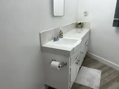 a white bathroom with a sink and a mirror at NoHo Cozy Cove in Burbank