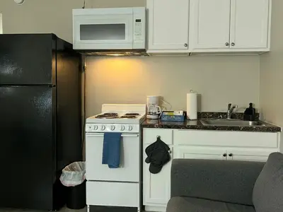 a kitchen with a white stove and a sink at NoHo Cozy Cove in Burbank