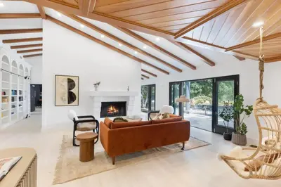 a living room with a couch and a fireplace at Malibu Park by Stay Awhile Villas in Malibu