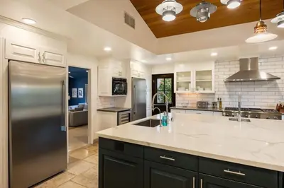 a large kitchen with a stainless steel refrigerator at Malibu Park by Stay Awhile Villas in Malibu