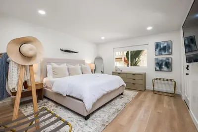 a bedroom with a bed with a hat on it at The South Bay Retreat in Redondo Beach