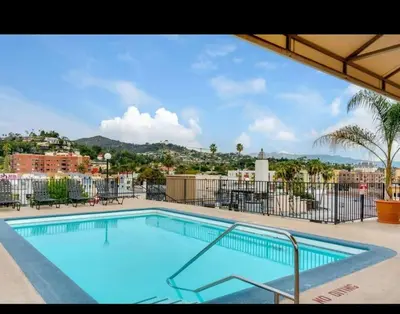 a large swimming pool with a view of a city at 2-Bedroom Hollywood Apartment in Los Angeles