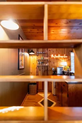 a kitchen with wooden walls and a counter top at BunkHouse 1960's Camp Vibe with Timeless Wet Bar in Springville