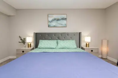 a bedroom with a blue bed with two lamps at Snazzy 2Bd Apartment Rooftop Pool & Iconic Hollywood Sign Views in Los Angeles
