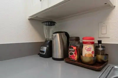 a kitchen counter with a blender on a shelf at Snazzy 2Bd Apartment Rooftop Pool & Iconic Hollywood Sign Views in Los Angeles