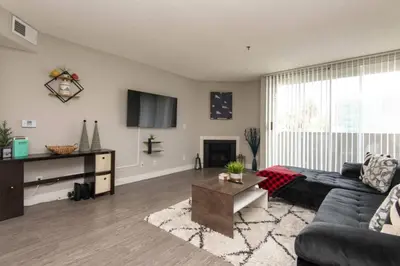 a living room with a couch and a table at Snazzy 2Bd Apartment Rooftop Pool & Iconic Hollywood Sign Views in Los Angeles