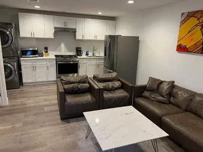 a living room with two couches and a kitchen at Private gated 1bed & 1bath amazing for 2 in Los Angeles near Universal studio & Hollywood in Van Nuys Airport