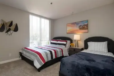 a bedroom with two beds and a window at 2BR Hollywood Apt Deluxe in Los Angeles