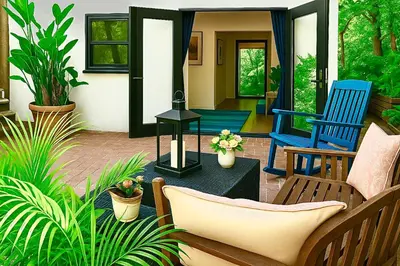 a patio with two blue chairs and a table at Enchanting Gated Hollywood Hills Oasis with Tranquil Treet-Top Views, Outdoor Living Room and Patios, Magical Zen Garden, Plus Bonus Romantic Guest House and Free Garage in LA's Most Desirable Central Serene Area, Sleeps 8-10 in Los Angeles
