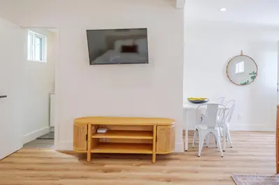 a living room with a table and a tv on a wall at Cute Guest Studio near Universal Studios sleeps 4 in Los Angeles