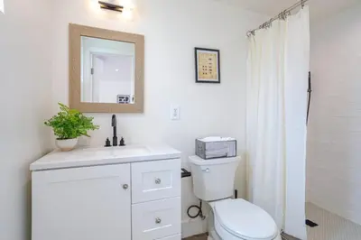 a bathroom with a toilet and a sink and a mirror at Cute Guest Studio near Universal Studios sleeps 4 in Los Angeles