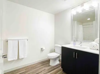 a white bathroom with a toilet and a sink at Studio Downtown Walk to Convention Center in Los Angeles
