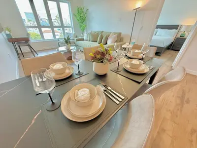 a dining room and living room with a table and chairs at 3 Bedroom 2 Bath Westwood Condo in Los Angeles
