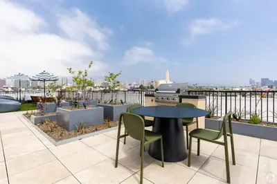 a patio with a table and chairs on a roof at 3 Bedroom 2 Bath Westwood Condo in Los Angeles