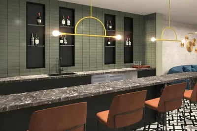 a bar with chairs and a counter with wine bottles at 3 Bedroom 2 Bath Westwood Condo in Los Angeles