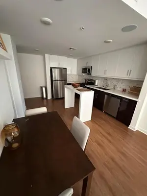 an empty kitchen with a table and chairs in it at Modern Unit Near Glendale Galleria and Walk to Shopping & Dining! in Glendale