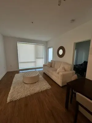 a living room with a couch and a table at Modern Unit Near Glendale Galleria and Walk to Shopping & Dining! in Glendale