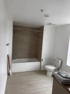 a bathroom with a bath tub and a toilet at Modern Unit Near Glendale Galleria and Walk to Shopping & Dining! in Glendale