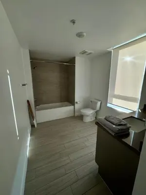 a bathroom with a tub and a toilet and a sink at Modern Unit Near Glendale Galleria and Walk to Shopping & Dining! in Glendale