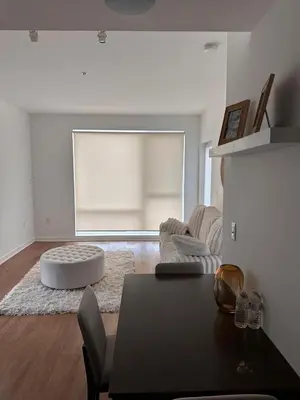 a living room with a table and a couch at Modern Unit Near Glendale Galleria and Walk to Shopping & Dining! in Glendale