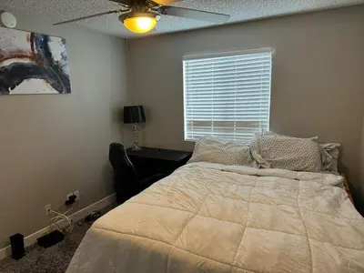 a bedroom with a bed and a ceiling fan at The Chic Loft in Riverside