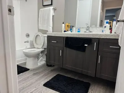 a bathroom with a sink and a toilet and a mirror at The Chic Loft in Riverside