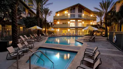 a swimming pool with chairs and a building at The Bleu Pearl 3Bed 2bath Venice Beach Santa Monica and Marina Del Rey in Los Angeles