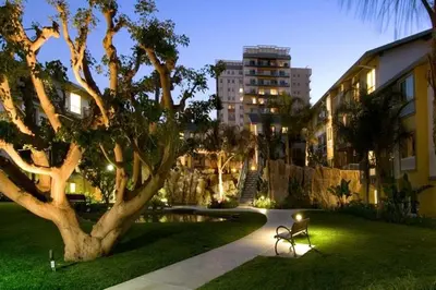 a park with a bench next to a tree and a building at The Bleu Pearl 3Bed 2bath Venice Beach Santa Monica and Marina Del Rey in Los Angeles