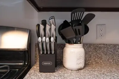 a container of kitchen utensils sitting on a counter at Chic Hollywood Retreat 2Bed Rooftop Pool with Iconic Views in Los Angeles