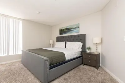 a bedroom with a large bed and a window at Hollywood Luxe 2BR Apartment with Rooftop Pool and Breathtaking Views in Los Angeles