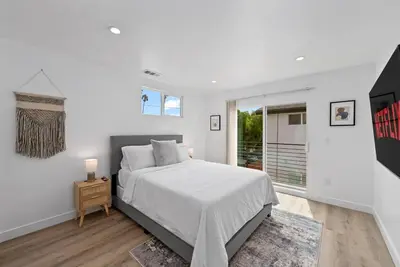 a white bedroom with a bed and a window at South Bay 3 bed Escape! in Harbor City