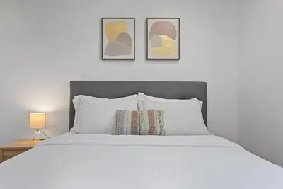 a bedroom with a white bed with two pillows at South Bay 3 bed Escape! in Harbor City