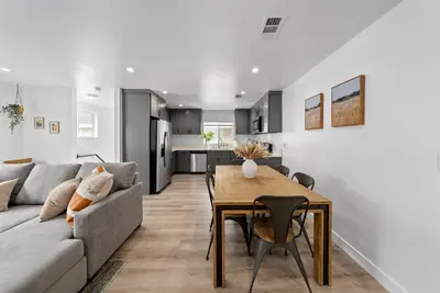 a living room with a couch and a dining room table at South Bay 3 bed Escape! in Harbor City