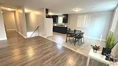 a living room with a dining table and a kitchen at The Blue Hostel - Near USC, BMO in Los Angeles
