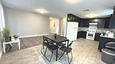 a kitchen with a table and chairs in a room at The Blue Hostel - Near USC, BMO in Los Angeles